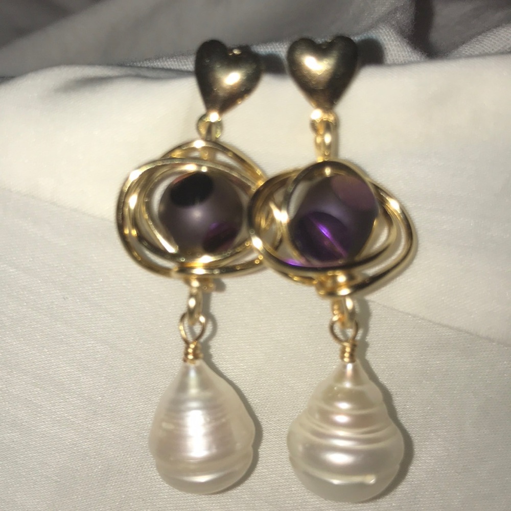 pearl earrings and purple stone detail